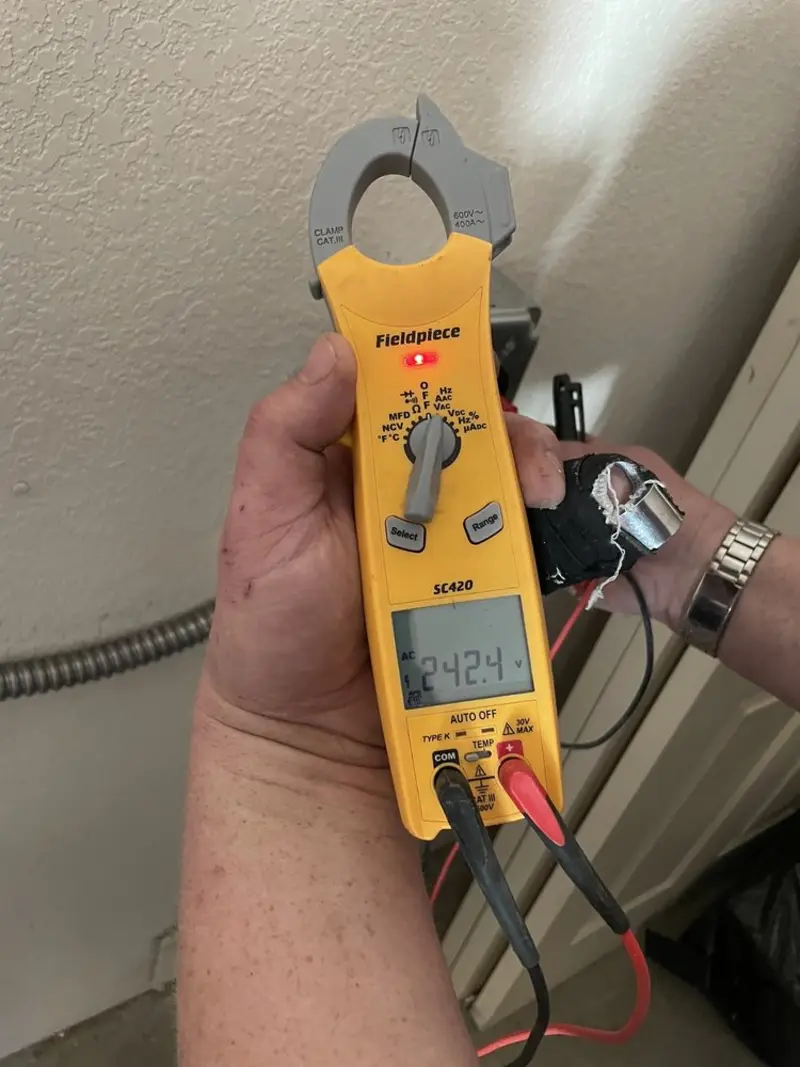 Voltage testing with clamp meter during Electrical Installation Services in Howland Center